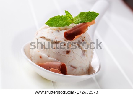 Scoop of stracciatella ice cream with chocolate curl