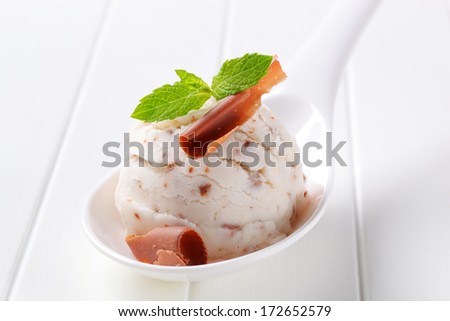 Scoop of stracciatella ice cream with chocolate curl
