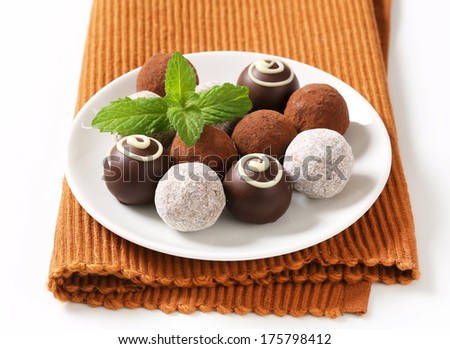 Chocolate truffles on white plate