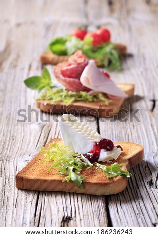 Three pieces of toast with various toppings