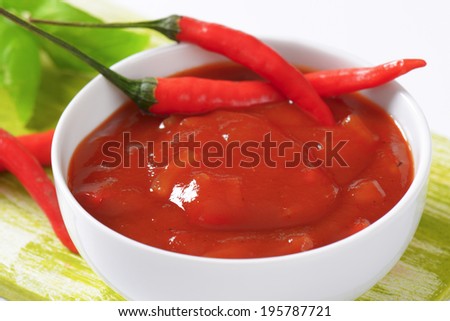 Bowl of spicy salsa dip with red chili pepper