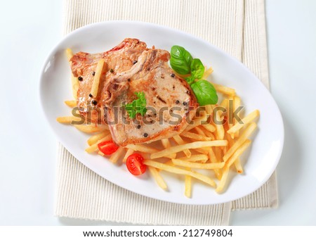 Pan seared pork chop with French fries