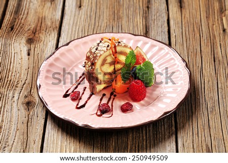 Chocolate Swiss roll garnished with fresh fruit