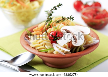 Tricolor pasta in a terracotta bowl