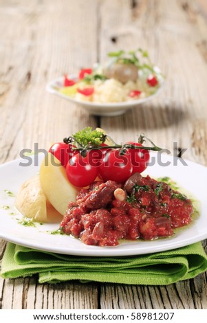 Vegetarian dish of beans and tomato with new potatoes