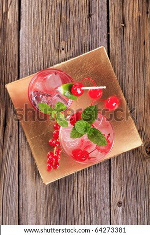 Glasses of iced drinks with maraschino cherries