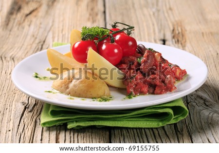 Vegetarian dish of beans and tomato with new potatoes