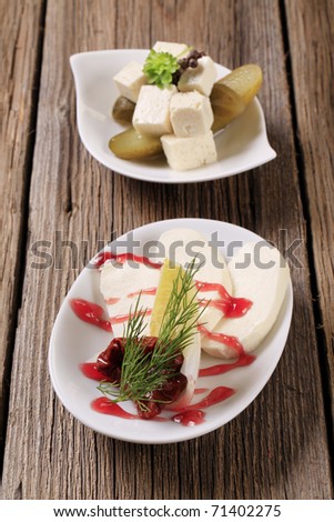 Slices of mozzarella and cubes of marinated feta cheese