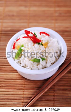 Small bowl of cooked white rice and chopsticks