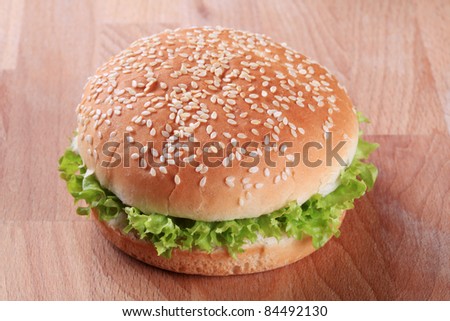 Sesame seed bun with cheese and fresh lettuce