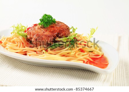 Meat patty and spaghetti