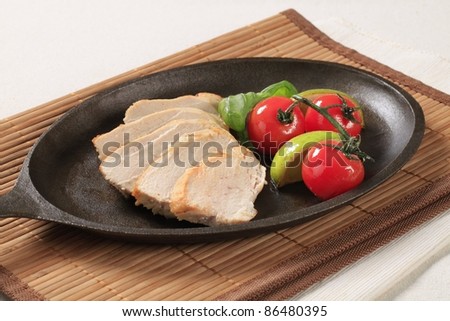 Slices of chicken breast fillet on a skillet