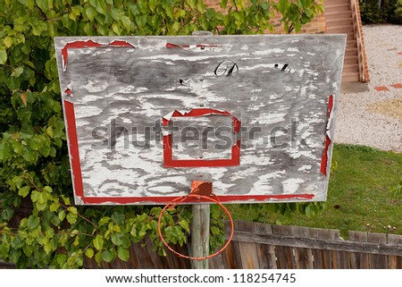 Old worn and weathered Basketball Backboard in a residential back yard