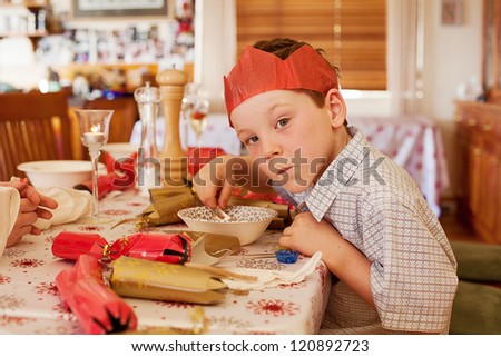 Young boy eating soup at Christmas lunch