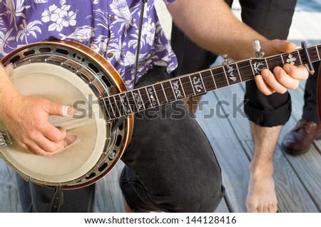 Close up detail of musicians hand on Banjo