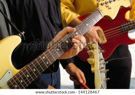 Close up detail of musicians hand on Electric Guitar