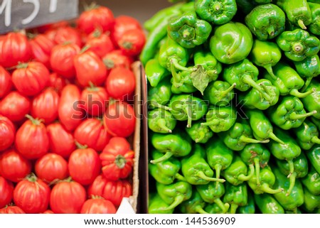 Green Chili Peppers and ripe red Tomatos on sale at the La Boqueria Food Market, Barcelona, Spain