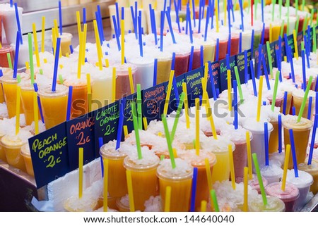 Colourful fresh fruit drinks for sale at La Boqueria food markets, Barcelona, Spain
