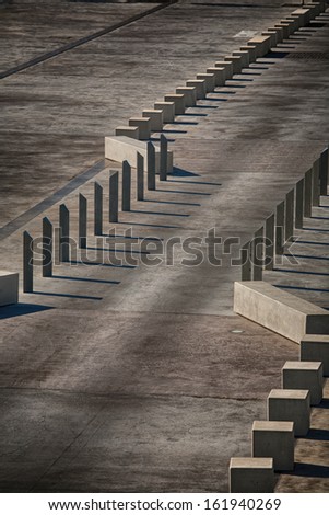 View of concrete traffic control barriers creating bastract patterns