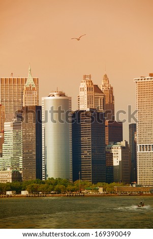 View of the Manhattan skyline at sunset, taken from the Staten Island ferry, as it crosses the Hudson River, New York