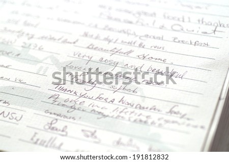Close up detail of handwritten entries in a guest book