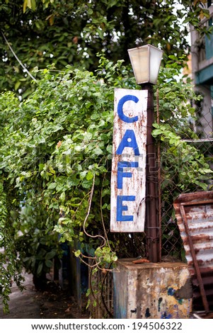 Old grungy Cafe Sign, on a street in Hue, Vietnam