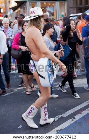 NY - JUNE 5 2013-Robert John Burck known as the Naked Cowboy performing his daily routine in New York City\'s Times Square  June 5th 2013.