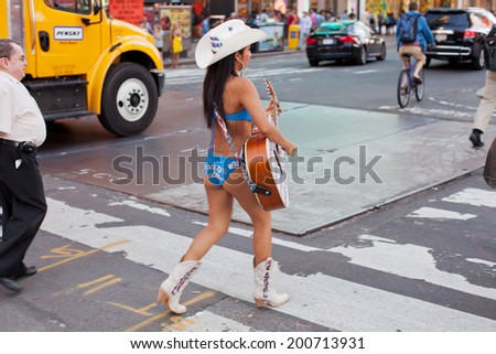 NY - JUNE 5 2013-One of several versions of the Naked Cowgirl performing her daily routine in New York City\'s Times Square  June 5th 2013.