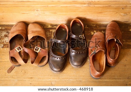 Group of leather shoes lined up at the front door