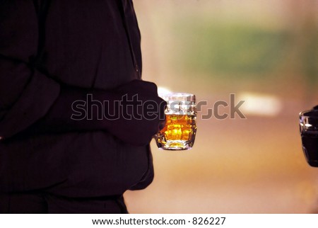 Silhouette of man with glass of icy cold beer