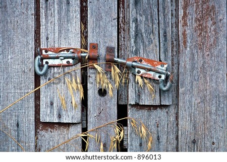 Detail of old door latches and timber doors of farm shed - stock photo