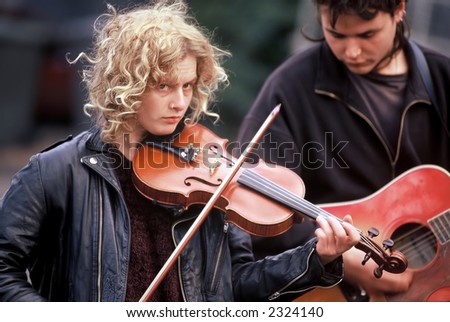 Violin playing performing at outdoor market