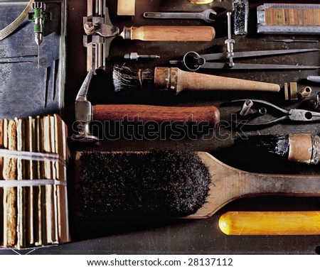 View looking down on a table of various Book Binding tools for use by hand