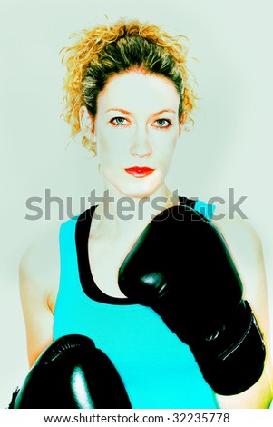 Female boxer sweating and resting after training in the gym
