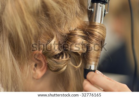 Young female having her hair styled in a hairdressing salon