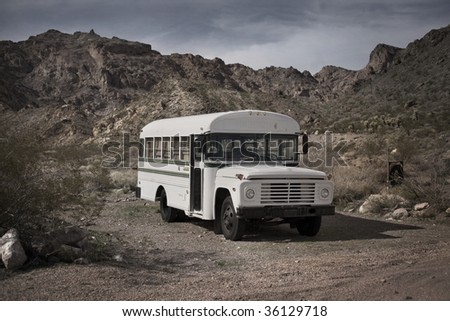 Old white school bus abandoned in a Cactus field, Nelson, Nevada, USA