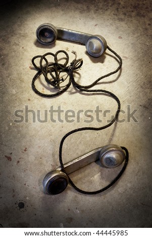 Still life of antique metal phone handsets and cloth covered cables
