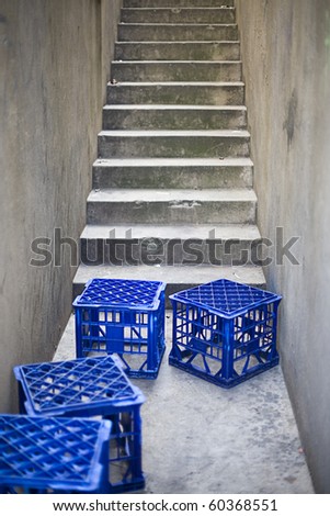 Back Alley in an urban city with concrete steps and blue plastic milk crates(deliberate very shallow depth of field)