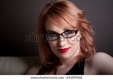 Beautiful Woman with Red hair and wearing black rim glasses