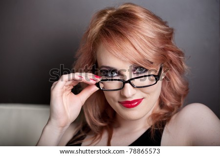 Beautiful Woman with Red hair and wearing black rim glasses