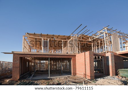 Residential construction site with partially completed home