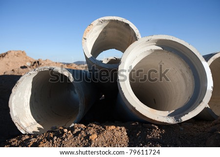 View of a construction site with concrete sewer drain pipes
