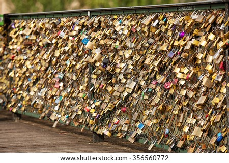 Paris, France-May 15, 2013. Thousands of padlocks known as love locks adorn the  Pont des Arts bridge that spans the Seine River in Paris, France