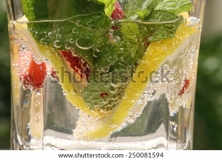 A refreshing drink of lemon-flavored soda infused with fresh strawberry, lemon, and mint leaves