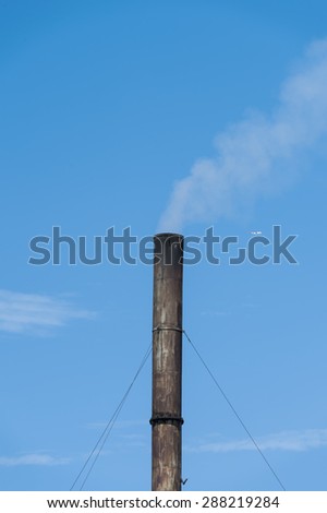 Old Factory plant with clear blue sky and cloud with small airpl