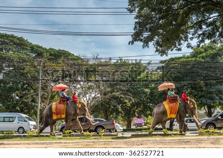 06 Jan 2016 : Tourists sightseeing Ayutthaya Historical park by sit on decoration elephant, Ayutthaya, Thailand, Asia