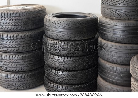 Car tires stacked in a tire distribution center