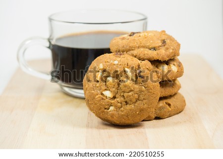 Almond cookies with black coffee background : Close up almond cookies on brown plate