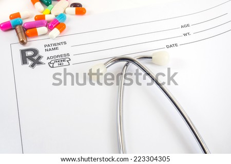 Medical concept Doctors Stethoscope and blank prescription form  With  colorful  pills ,  space for your message