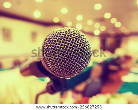 Microphone in concert hall or conference room with defocused bokeh lights in background. Extremely shallow dof. : Vintage style